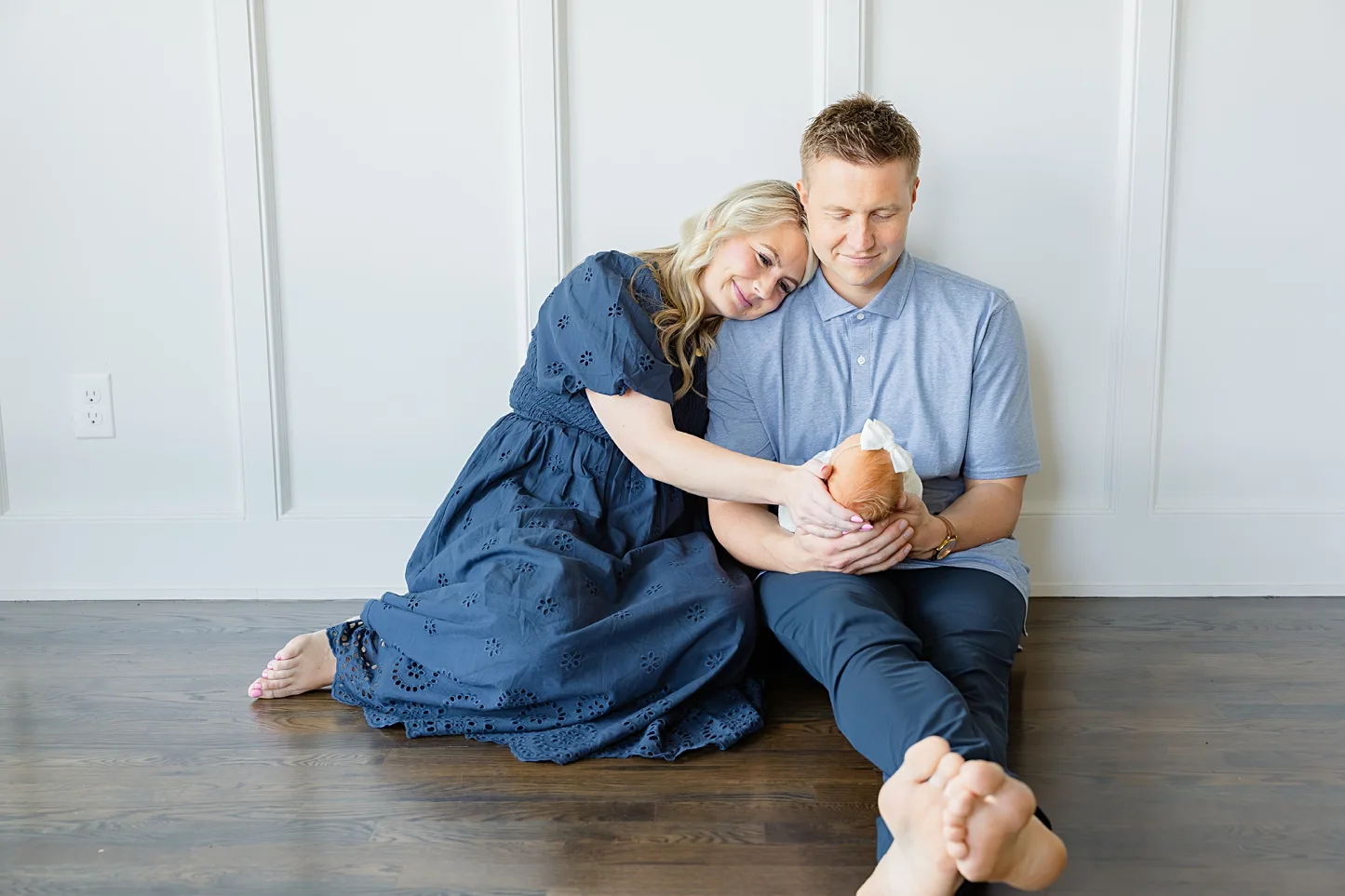 New parents with baby during at home newborn photos.