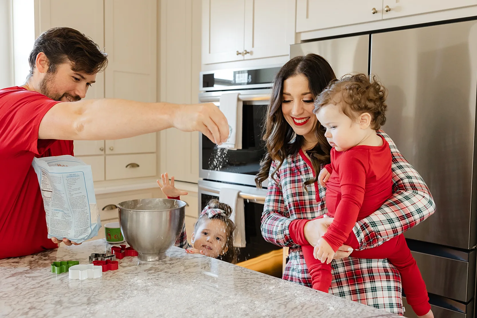 New parents with baby during at home newborn photos.